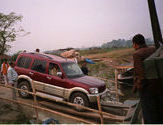 Scorpio in Motion on Two Planks by theyyamdancer.  Tags: Dibrugarh, Assam, Arunachal Pradesh, Transportation.