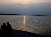 Few guys sitting on top of ferry crossing Brahmaputra by amalp.  Tags: Assam, ferry, Brahmaputra.
