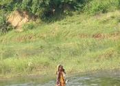 TRIBAL CROSSING A STREAM by SOMA ROY.  Tags: People and Faces, Tribal Culture.